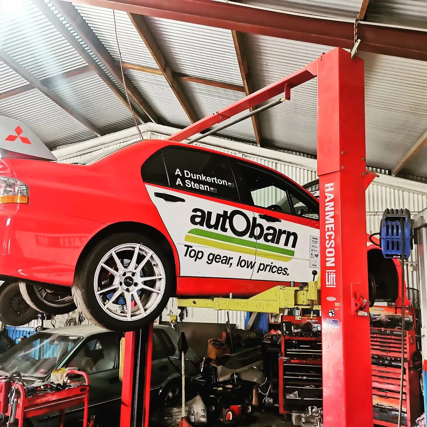 Mitsubishi Lancer Evo race car on a hoist in the S & A Automotive workshop in Cairns