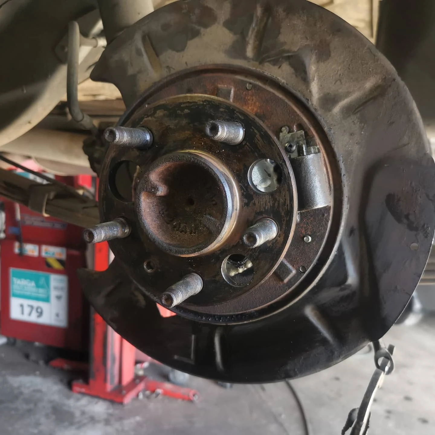 Wheel hub and rusted brake rotor exposed during a brake service at S & A Automotive Cairns