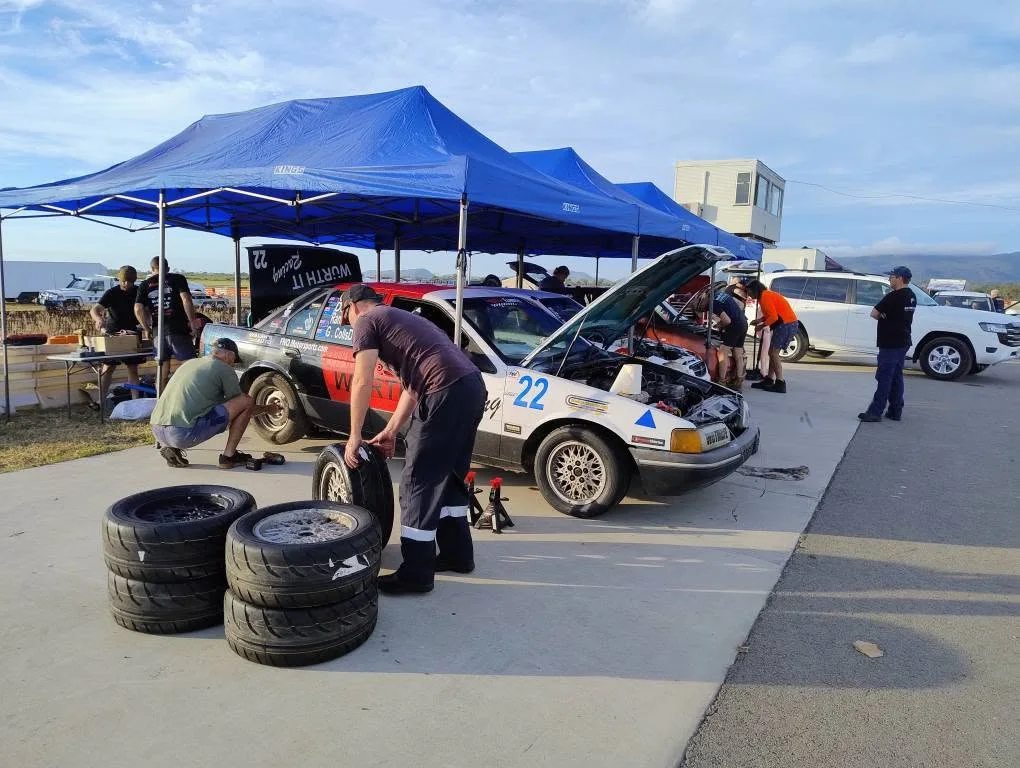 Wotmafe Racing pit crew servicing race car #22 trackside in North Queensland
